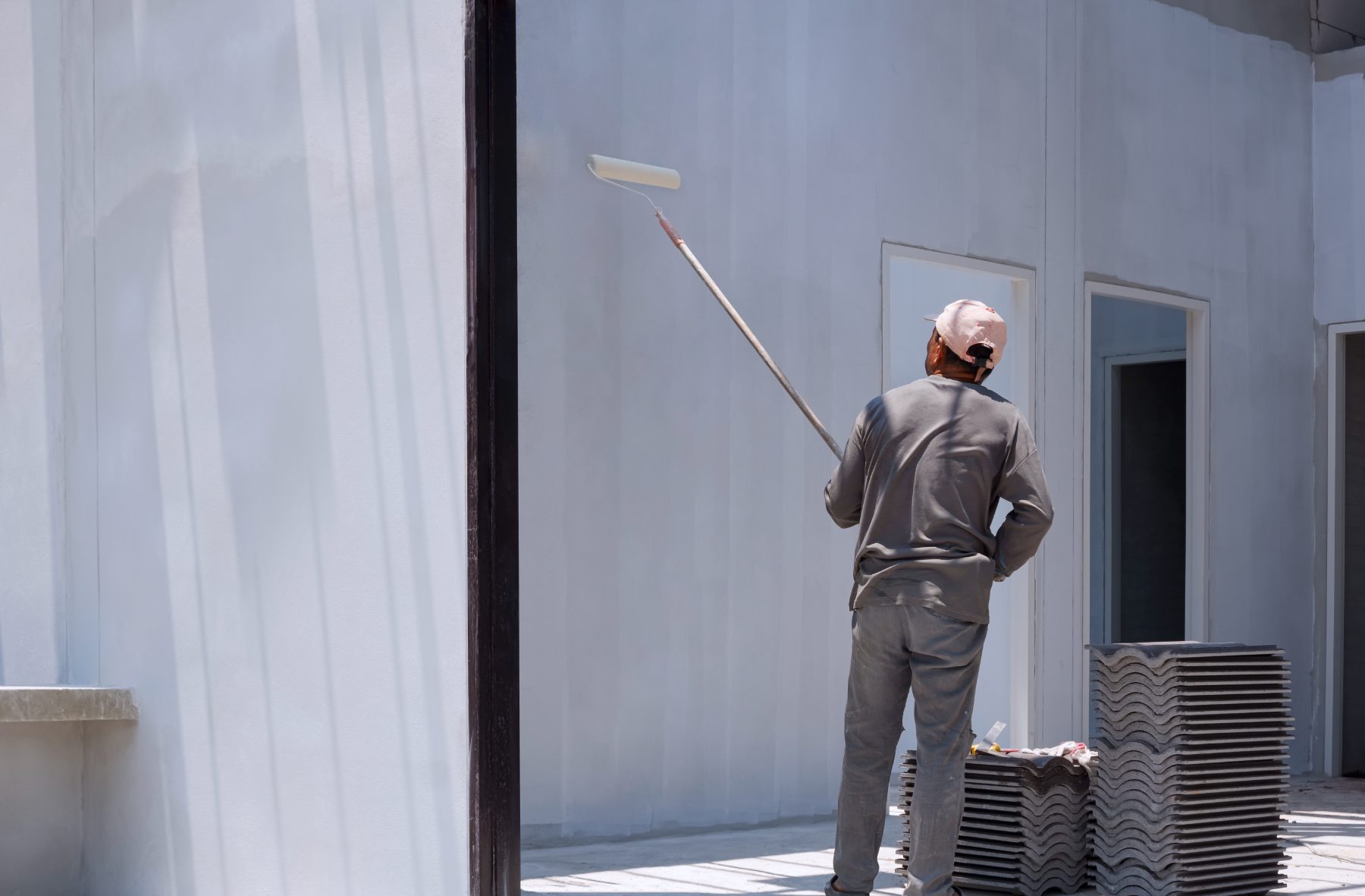 Painter rolling a wall.